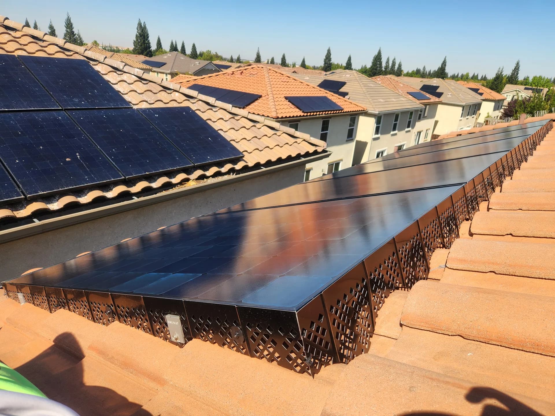 Solar panel birdproofing mesh on a clay tile roof in a Rocklin neighborhood
