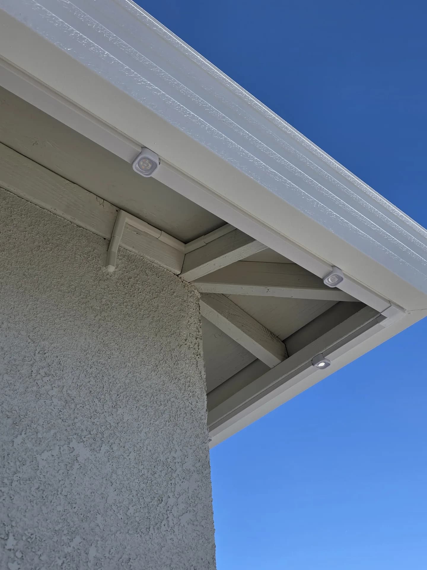 Close-up of permanent Christmas light modules installed on a gable fascia