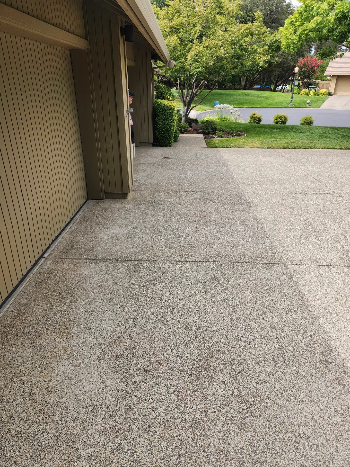 Hot pressure washing result on a residential concrete driveway in the Greater Sacramento area