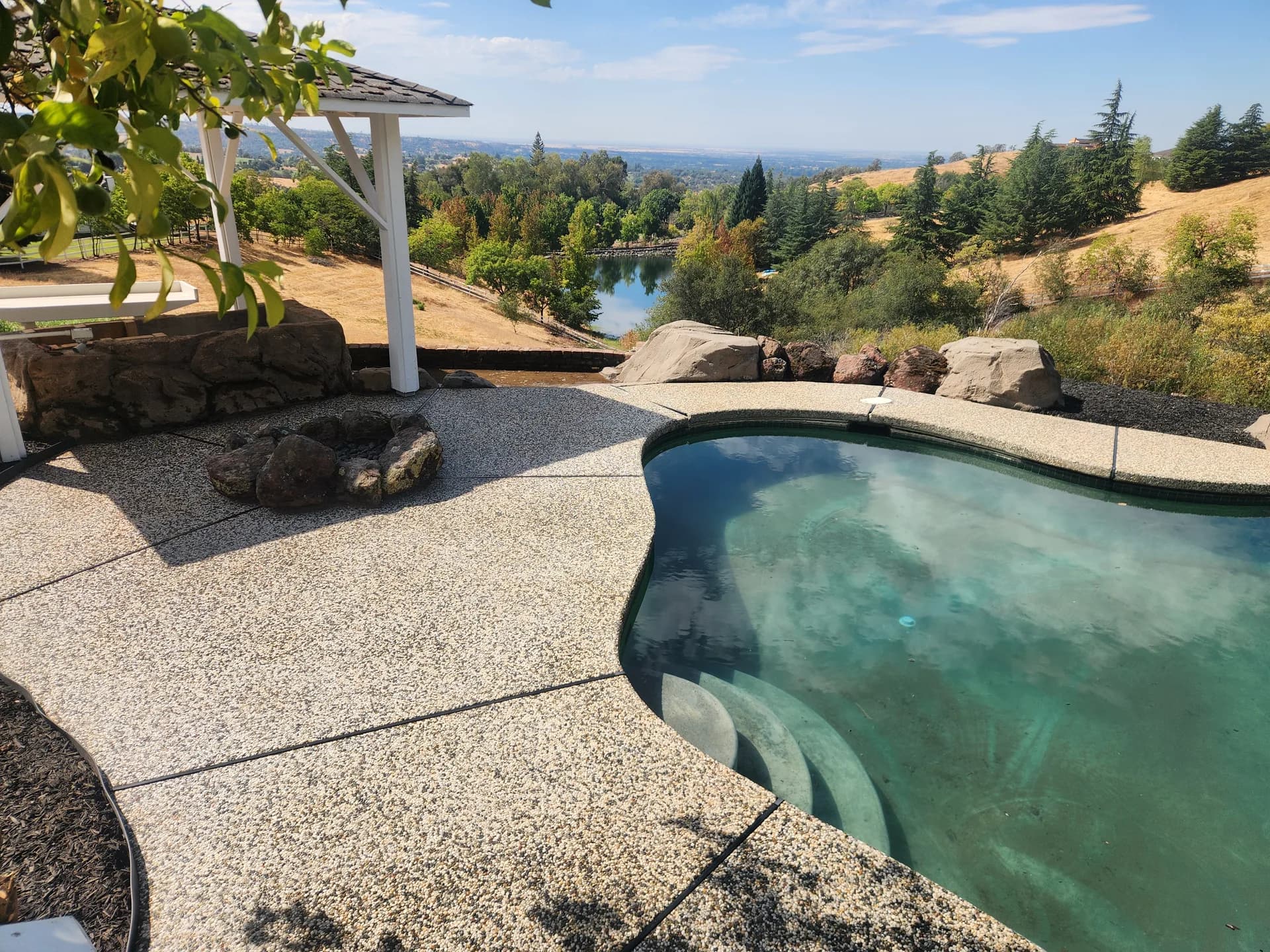 Clean exposed-aggregate pool deck after pressure washing in Rocklin, CA