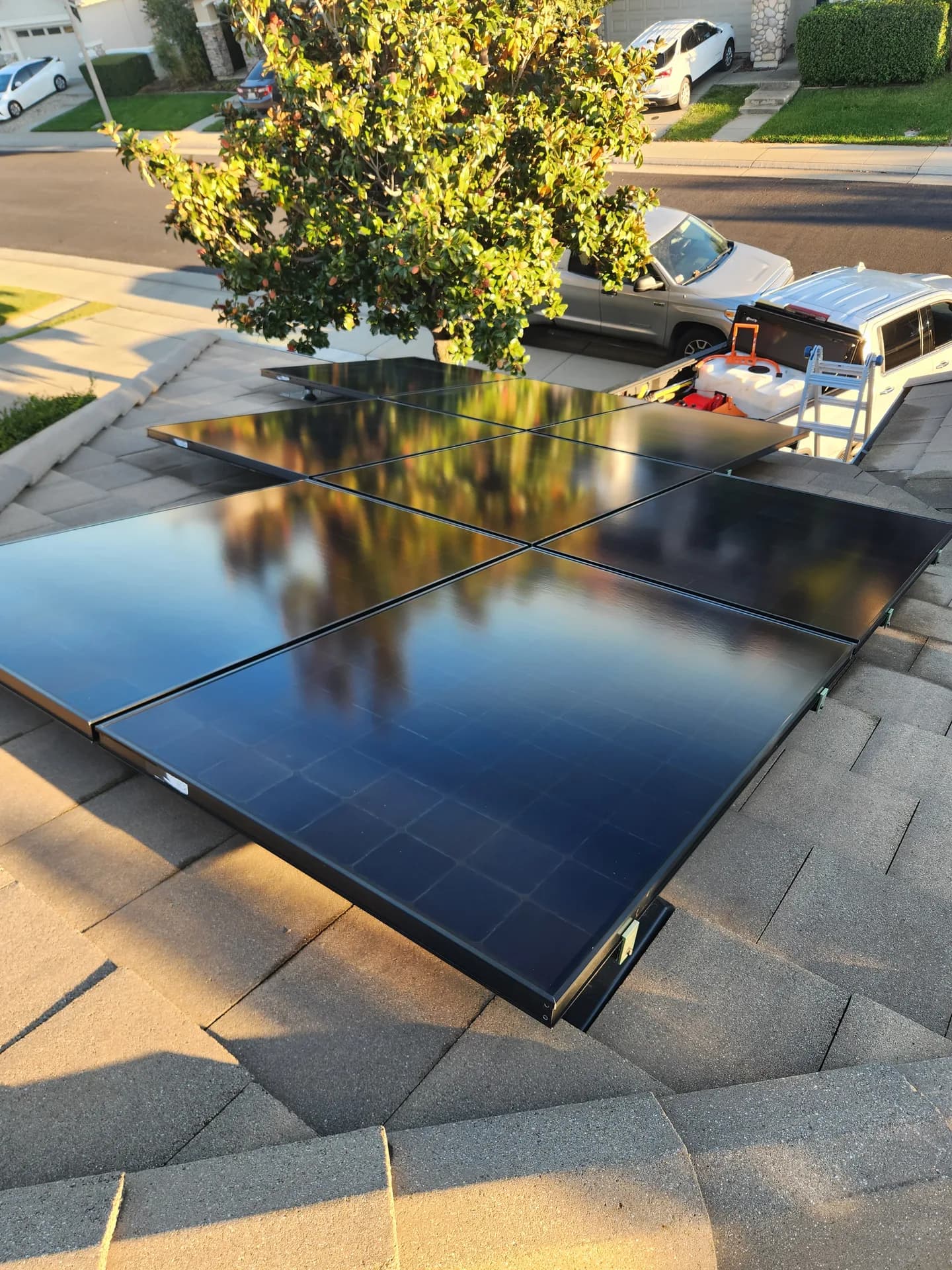 Freshly cleaned rooftop solar panels on an asphalt-shingle roof in the Sacramento area