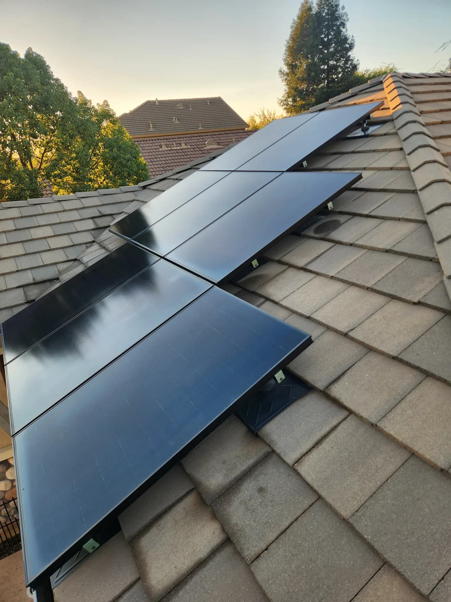Residential solar array after cleaning on a shingle roof at sunset