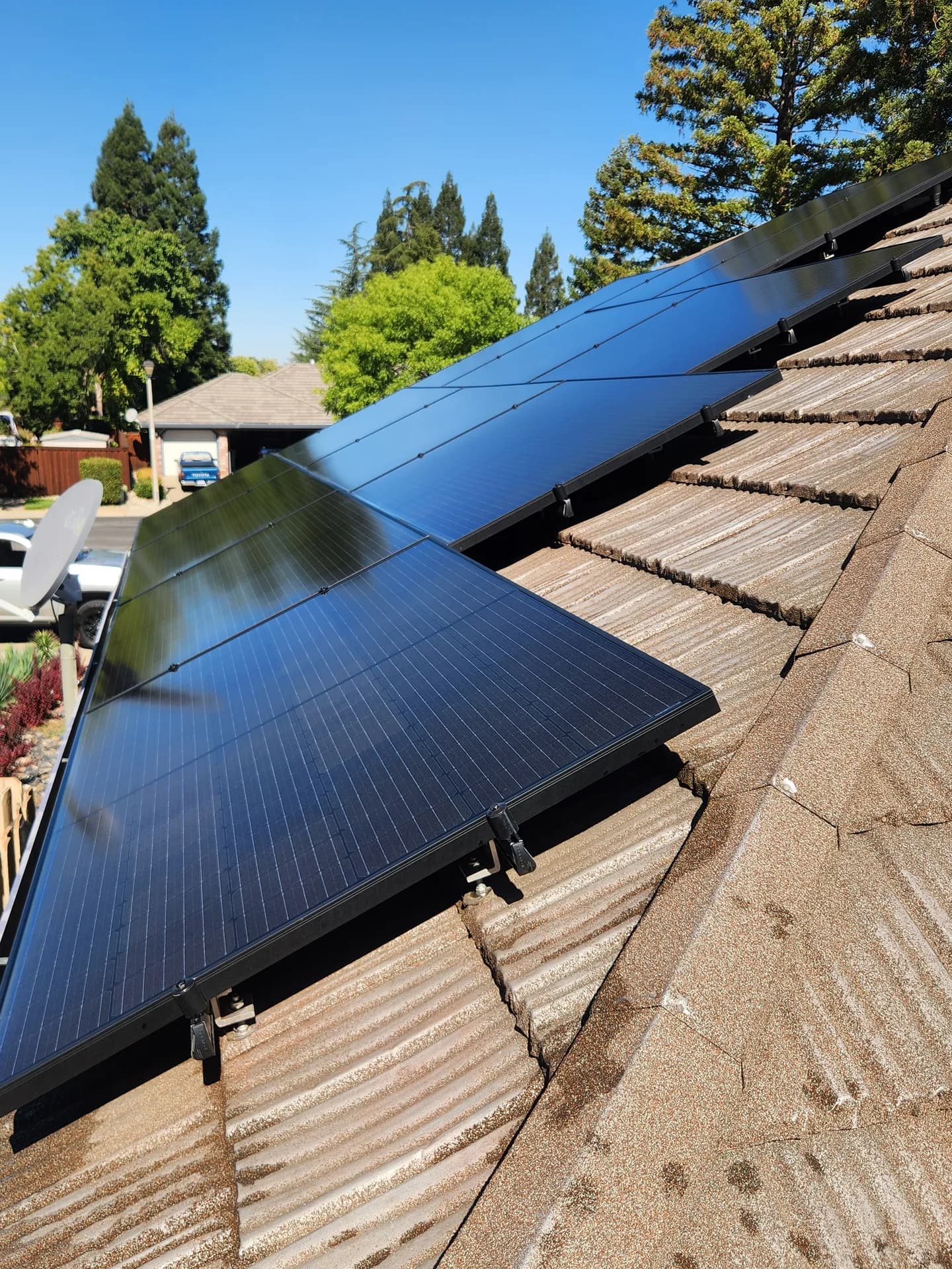 Close-up of solar panels after soft-brush cleaning, glass restored to a deep blue shine